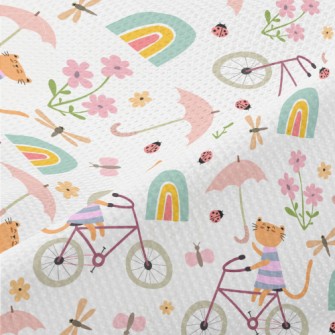 Kitten Riding A Bicycle In The Piqué
